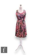 A 1960s vintage sleeveless silk shift dress, with pleated flared skirt and original waist belt,