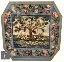 A collection of six early 20th Century framed needlework samplers, each with a similar rural scene