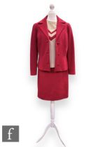 A 1960s vintage red three piece suit, comprising structured jacket with button fastening, pencil