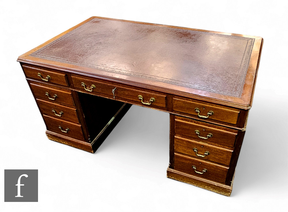A 1930s or earlier mahogany pedestal desk fitted with three frieze drawers below a moulded edge