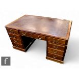 A 1930s or earlier mahogany pedestal desk fitted with three frieze drawers below a moulded edge