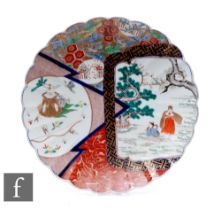 An early 20th Century Japanese scalloped rim imari dish, the central field with segmented fan shaped