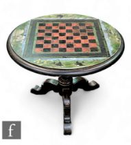 A Victorian black slate games table, raised on wooden ebonised triform base, the circular black