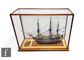 A 20th Century painted wooden scale model of HMS Victory in oak display case, 86cm x 64cm.