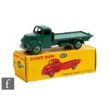 A Dinky 422 Fordson Thames Flat Truck in dark green body with mid-green ridged hubs, boxed.