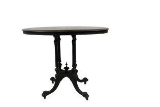An Aesthetic period ebonised and inlaid oval Loo Table, with reeded pillar supports on a