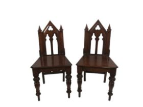 A pair of 19th Century Gothic Revival stained oak Hall Chairs, with arched and open backs over