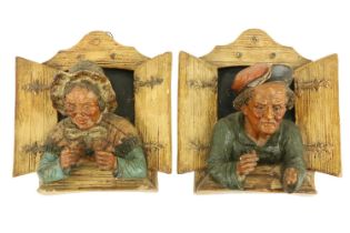 A good pair of late 19th Century German terracotta Wall Figures, modelled in high relief depicting