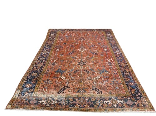 A fine quality semi-antique heavy woollen Carpet, the central panel on burgundy ground with floral