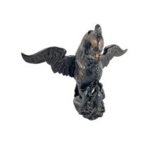 A carved wooden Eagle Crest, with chicks and outstretched later wings, 33cms (13"). (1)