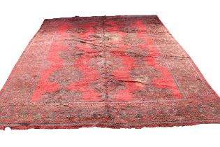 A large Oriental design woollen Carpet, probably Donegal, on overall red ground with floral