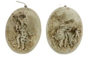 An unusual pair of late 19th Century Continental oval porcelain Plaques, each with figures set in
