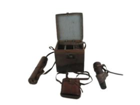 Military interest: A large leather cartridge carrying Case; a military Binoculars, in leather