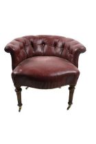 An Edwardian Tub Armchair, covered in deep button red leather on front reeded legs with bass