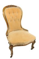 A Victorian Ladies walnut Nursing Chair, with balloon shaped button back, covered in light tan