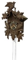 A late 19th Century Swiss oak framed Hanging Cuckoo Clock, with carved bird and leaf decoration,