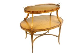 A two tier Edwardian satinwood inlaid and crossbanded Supper Table, with oval shelves, the top