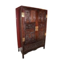 A carved hardwood Cabinet (GUI) Qing Dynasty, of rectangular outline with a pair of hinged doors