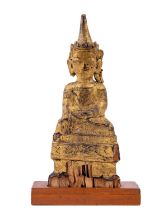 An early Burmese carved wooden and parcel gilt seated Buddha, 23cms (9'') on later mahogany