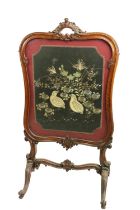 A cartouche shaped Victorian mahogany cheval Firescreen, with stump work and needle work panel on