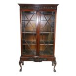 A mahogany Display Cabinet, in the Chippendale style, 20th Century, the dentil moulded cornice above