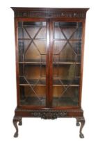 A mahogany Display Cabinet, in the Chippendale style, 20th Century, the dentil moulded cornice above