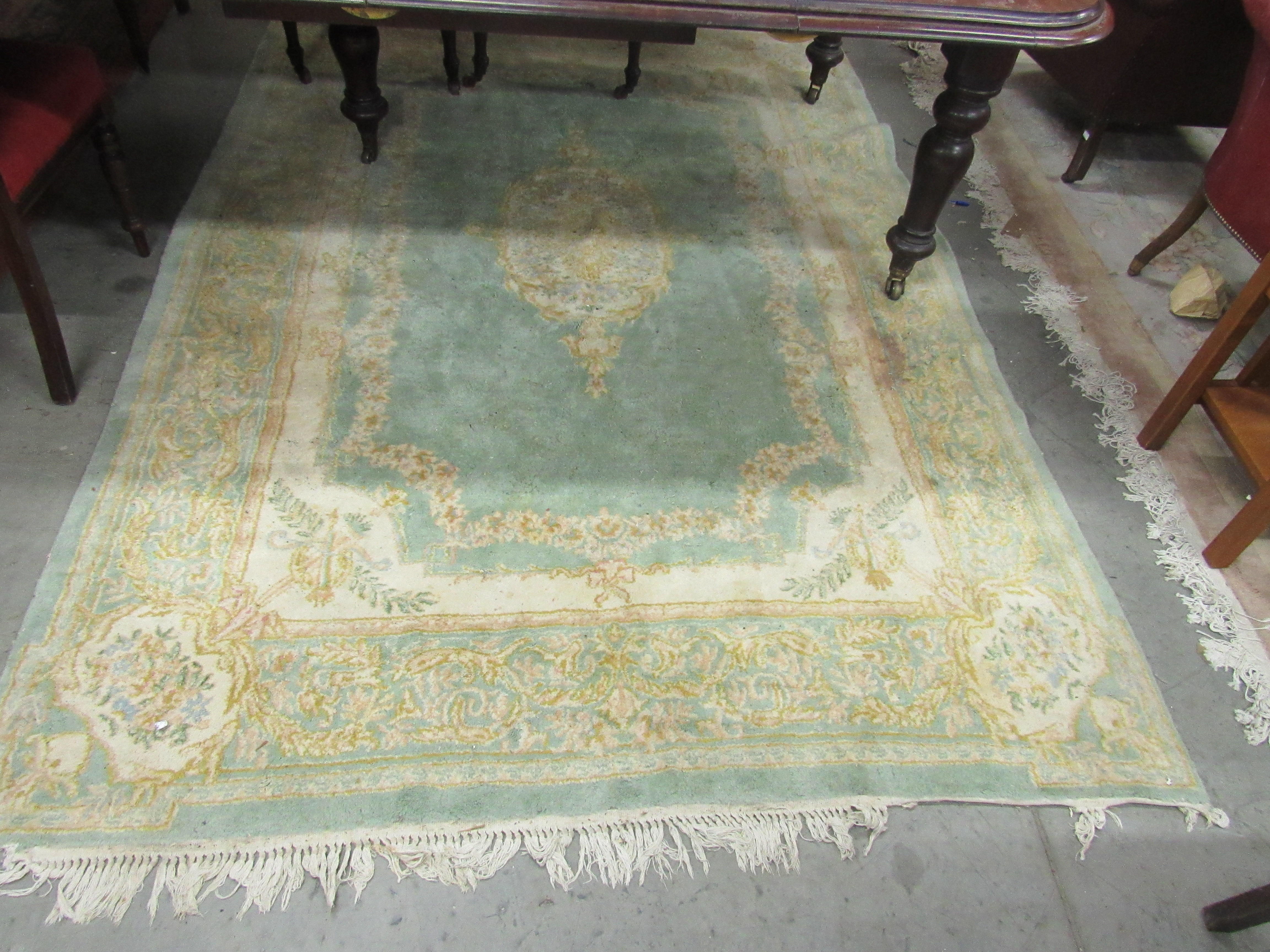 A lime ground heavy woollen classic design Carpet, with central medallion trophy motif corners