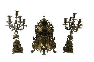 A French style brass Clock Garniture, the dome pierced decorated Clock with circular dial and