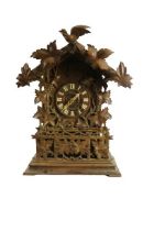 An early 20th Century oak and walnut Austrian 'Cuckoo' Clock, the arched cornice with leaf