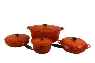 A large oval shaped two handled Le Creuset orange colour Casserole Pot and Cover; a small circular