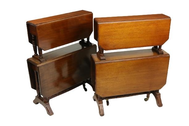 An unusual pair of Edwardian walnut two tier Sutherland Tables, each tier with two rectangular flaps