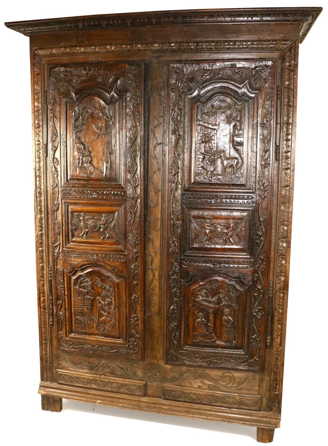 A heavy carved late 18th Century Continental walnut and oak Cupboard, the two triple panel doors