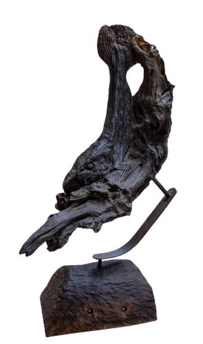 'An Bradán - The Salmon,' a natural bog oak design, mounted on a metal stand with wooden base,