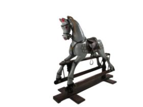 An Edwardian Hobby Horse, the painted body with mane and tail, leather straps and seat on wooden and