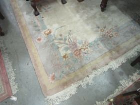 A large Chinese woollen cream ground Carpet, with floral decorated border, approx. 360cms long x