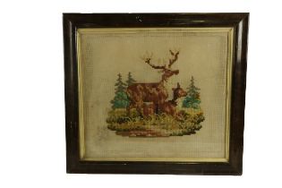 A large 19th Century Needlework Tapestry, depicting a stag and deer resting in forest setting,