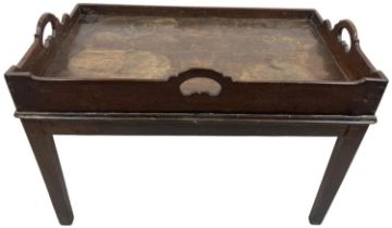 A late 19th Century oak Butlers Tray, with three saw cut handles, now on a fixed stand on square