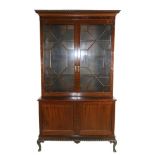A George III style plum pudding mahogany Bookcase, with gadroon and Greek key moulded cornice, above