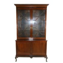 A George III style plum pudding mahogany Bookcase, with gadroon and Greek key moulded cornice, above