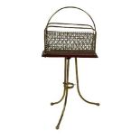 A tubular brass and brass wire mesh Magazine & Newspaper Stand, on tripod base with arched centre,