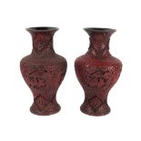 A pair of 19th Century Chinese cinnabar baluster shaped Vases, with landscape and figural panels,