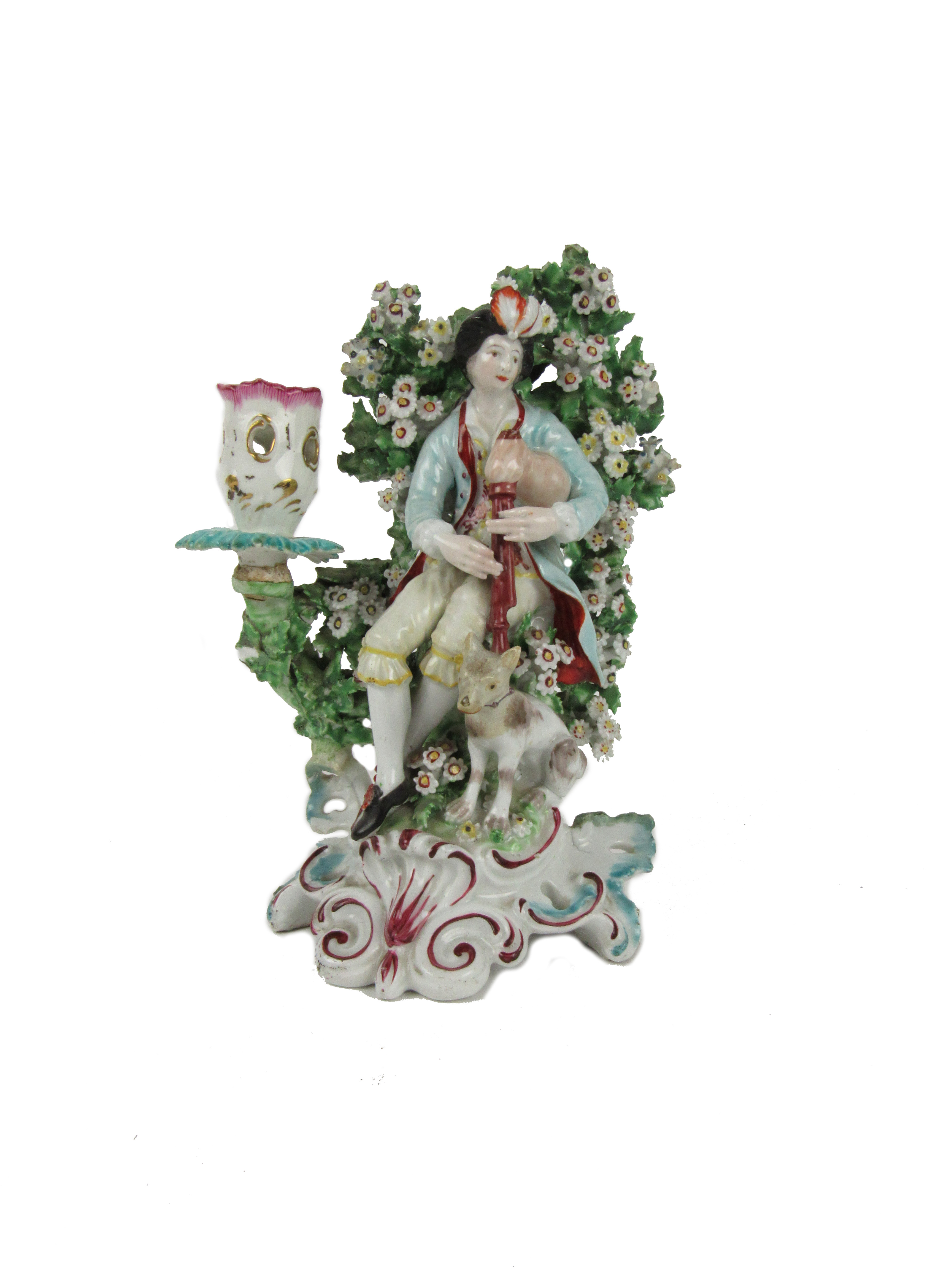 An early Derby flower encrusted porcelain Candlestick, of a Piper and a Dog, approx. 19cms. (1)