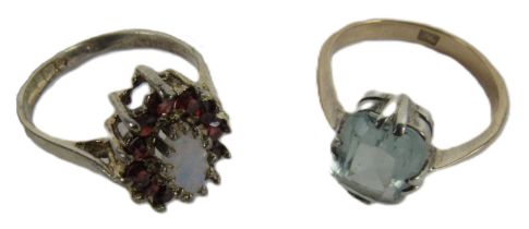 A Ladies silver gilt Ring Set, with central oval opal stone, surrounded by a ruby coloured garnet