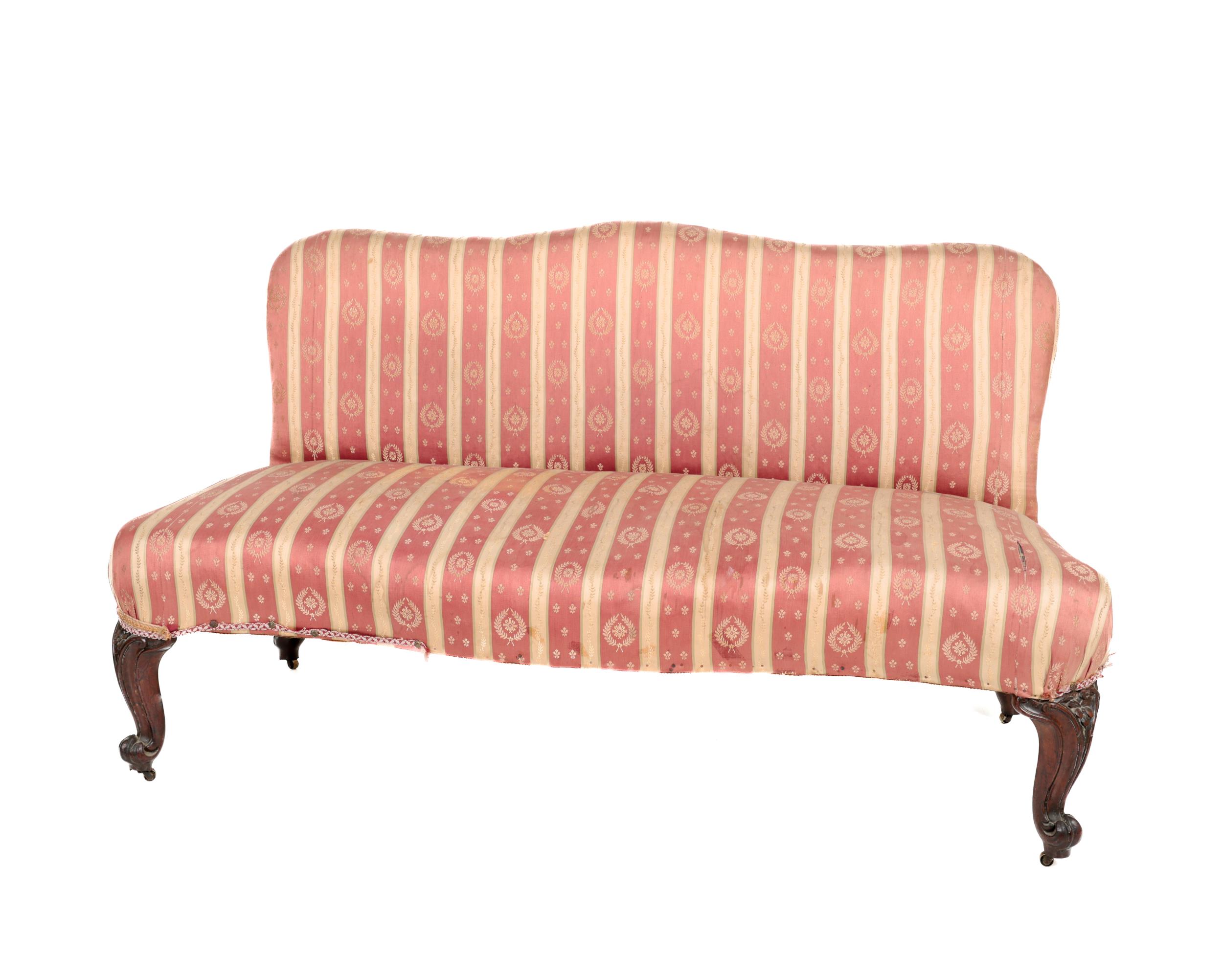 A Victorian mahogany framed humpback Couch or Window Seat, covered in Regency stripe fabric on front