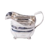 A Georgian period Irish silver bright cut Cream Jug, by James Le Bas, Dublin 1813, with a central