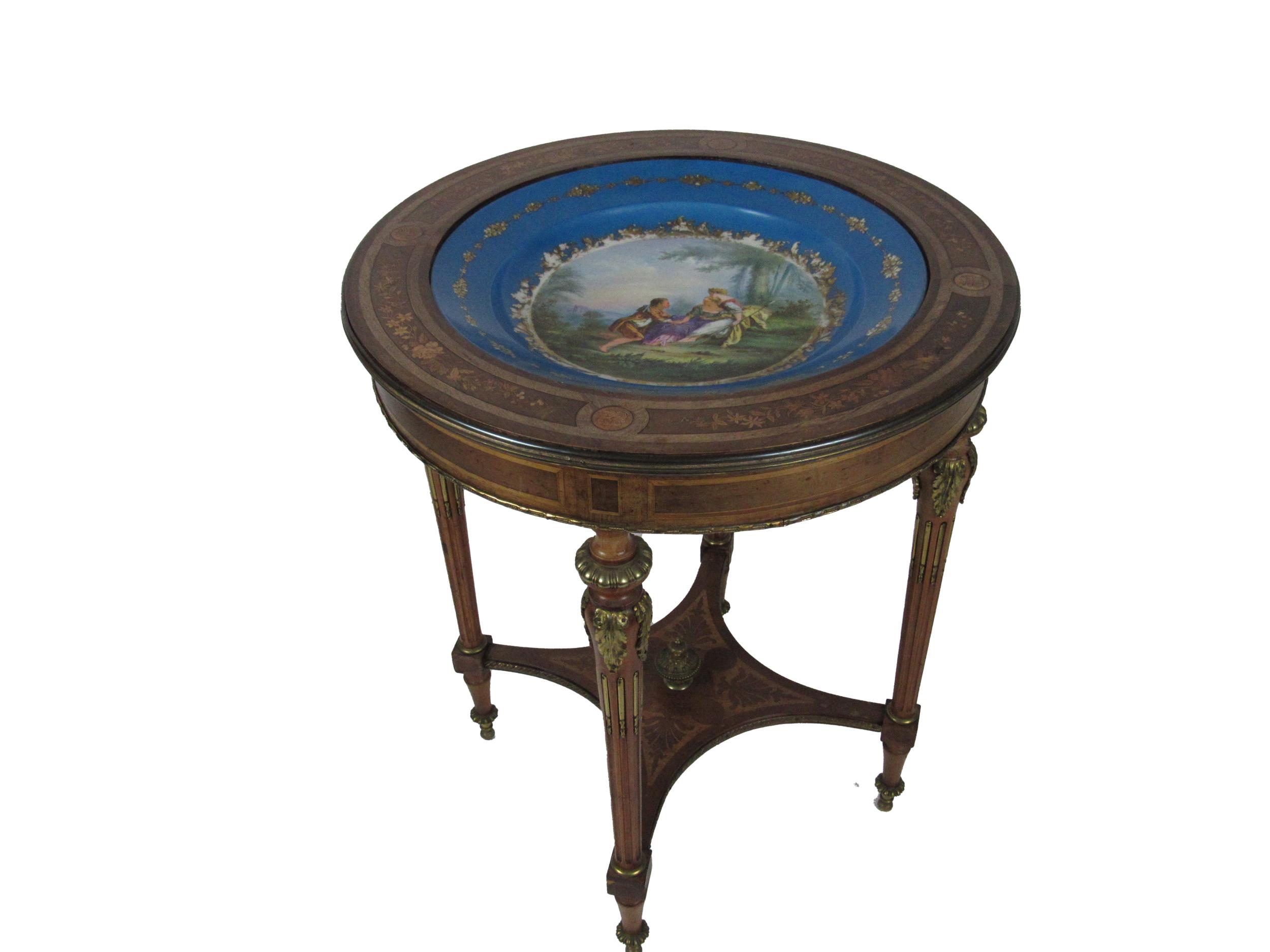 An attractive French Louis XVI style circular Table, the top inset with Sevres type decorated bowl