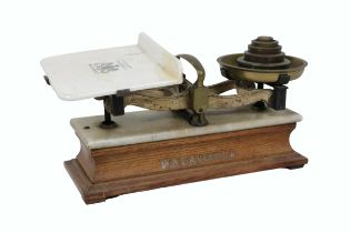 An Edwardian W. & T. Avery Weighing Scales, with weights, porcelain balance on an oak base. (1)