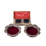 A pair of decorative silver plated Wine Coasters, the wooden centre with circular engraved plated