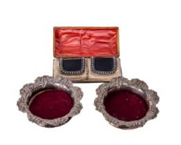 A pair of decorative silver plated Wine Coasters, the wooden centre with circular engraved plated