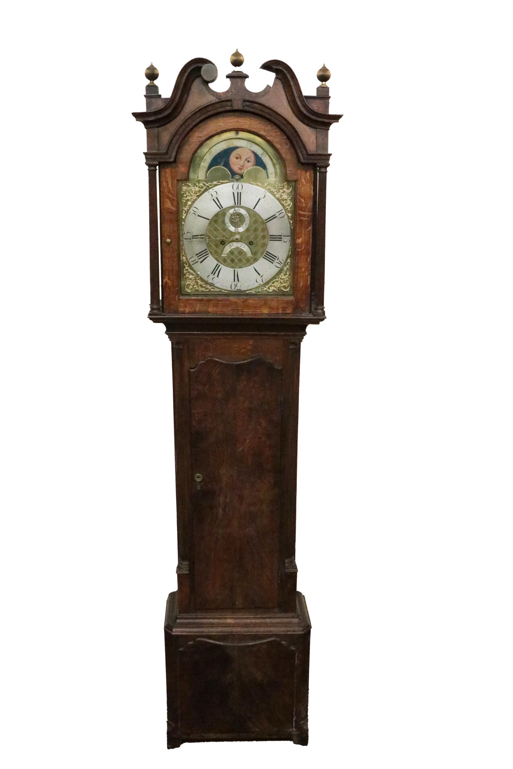 A 19th Century English oak cased Grandfather Clock, the swan neck pediment with brass finials over